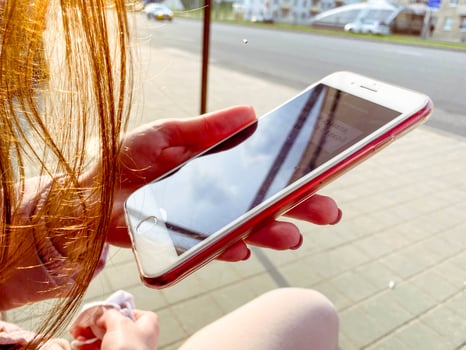 Close up of women's hands holding cell telephone with blank copy space scree for your advertising text message or promotional content, hipster girl watching video on mobile phone during coffee break. photo