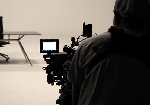 Behind the scenes or making of film in the studio and silhouette of camera man. photo