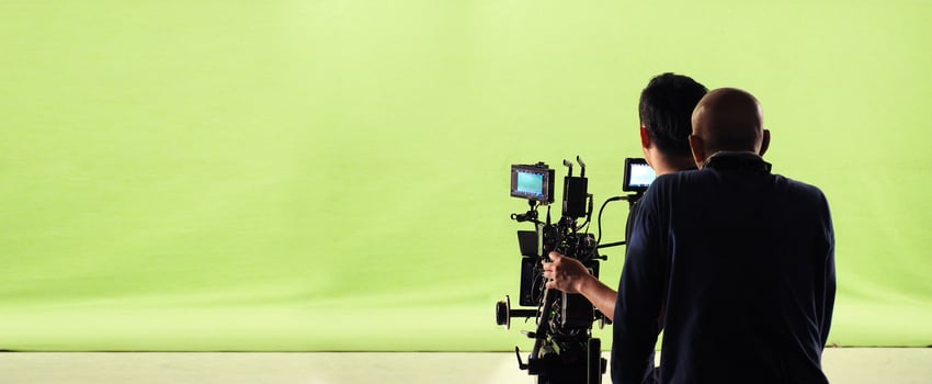 Camera and green screen studio in panorama view and man working or shooting or recording or filming. photo