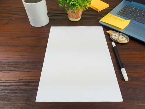 Flat lay, mock up paper. workspace in the background of the office desk from the top view. with blank white paper, laptops, office supplies, pencils, green leaves, and coffee cups photo