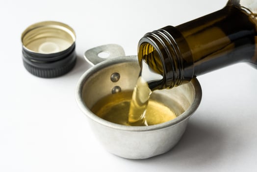 Pouring Avocado Oil in a Measuring Cup photo