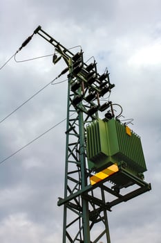Green power pole on dark gloomy clouds background in Germany. photo