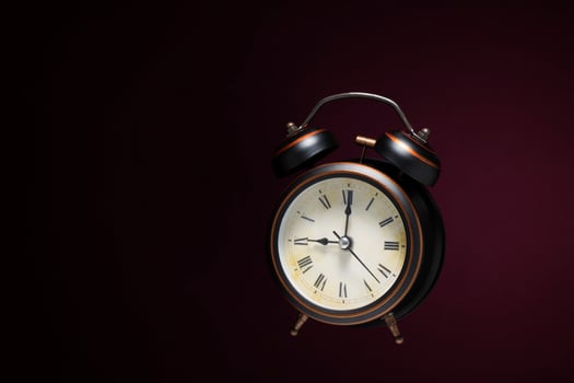 retro style black alarm clock on a black background photo