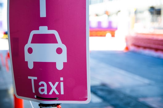 Taxi pick-up point sign in pink color. photo