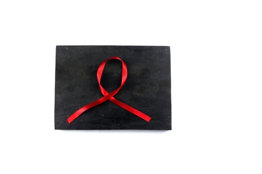 red aids ribbon on old wood background photo