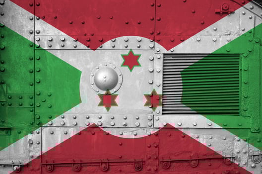 Burundi flag depicted on side part of military armored tank closeup. Army forces conceptual background photo
