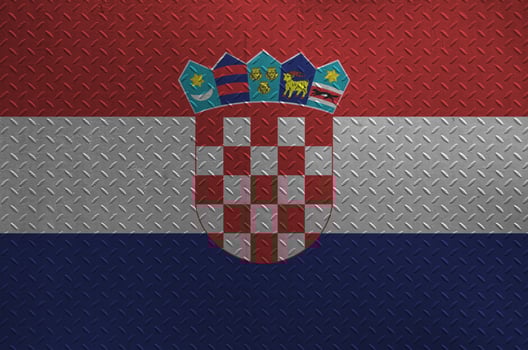 Croatia flag depicted in paint colors on old brushed metal plate or wall closeup. Textured banner on rough background photo