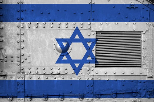 Israel flag depicted on side part of military armored tank closeup. Army forces conceptual background photo