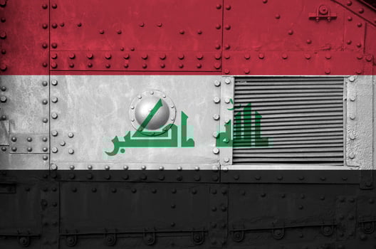 Iraq flag depicted on side part of military armored tank closeup. Army forces conceptual background photo