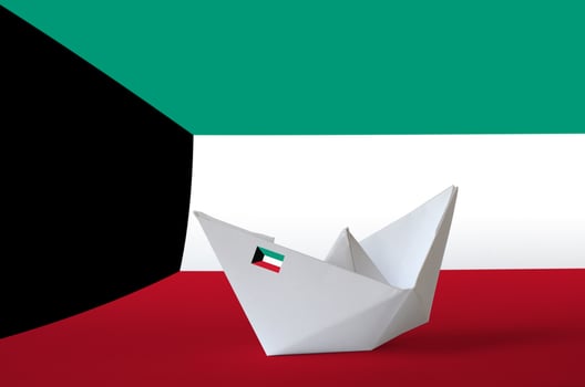 Kuwait flag depicted on paper origami ship closeup. Handmade arts concept photo