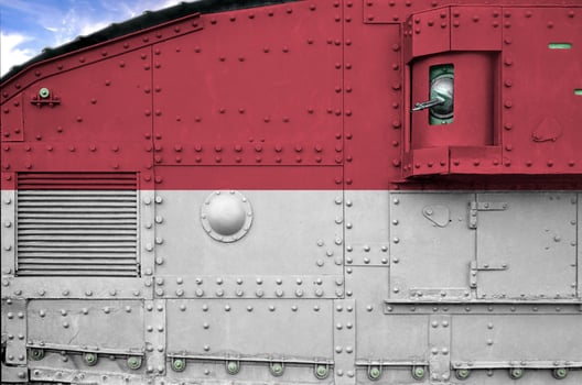 Monaco flag depicted on side part of military armored tank closeup. Army forces conceptual background photo