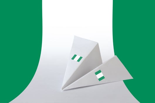 Nigeria flag depicted on paper origami airplane. Handmade arts concept photo