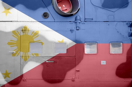 Philippines flag depicted on side part of military armored helicopter closeup. Army forces aircraft conceptual background photo