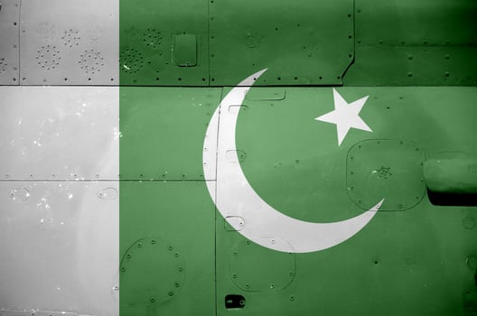 Pakistan flag depicted on side part of military armored helicopter closeup. Army forces aircraft conceptual background photo