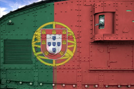 Portugal flag depicted on side part of military armored tank closeup. Army forces conceptual background photo