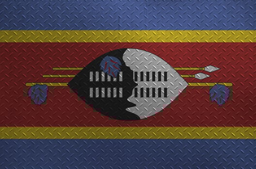Swaziland flag depicted in paint colors on old brushed metal plate or wall closeup. Textured banner on rough background photo
