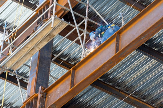 man welding steel on a girder at heights, building structure, mexico guadalajara photo