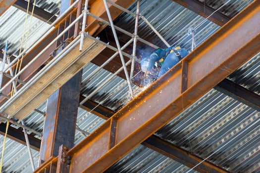 man welding steel on a girder at heights, building structure, mexico guadalajara photo