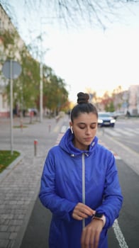 Front view of beautiful woman is jogging outdoor autumn day. photo