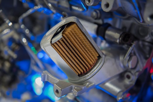 Engine oil filter cross section on the car engine,  it necessary to replace an oil filter every oil change, automotive maintenance service concept. photo