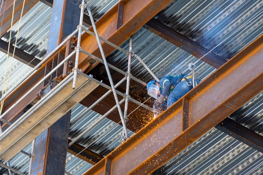 rusted steel structure while a man is welding joints, mexico guadalajara photo
