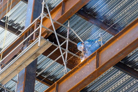 rusted steel structure while a man is welding joints, mexico guadalajara photo