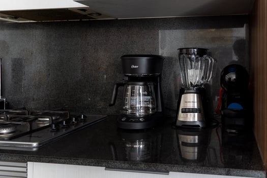 Different clean plates in dish drying rack on kitchen counter photo