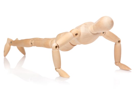 Small wooden dummy during push ups photo