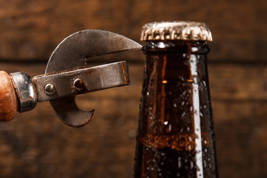 Bottle of beer and vintage opener photo