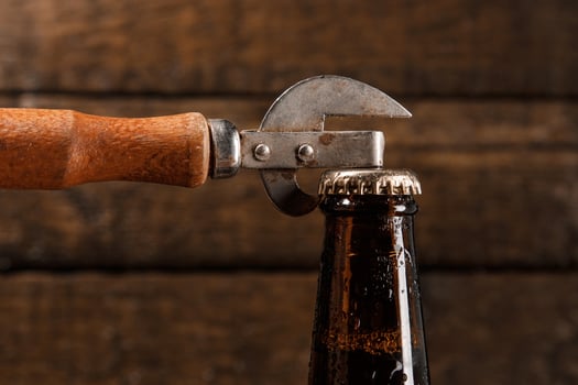 Bottle of beer and vintage opener photo