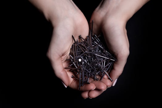 Woman's hands holding screws and dowels in palms. Isolated on black. female hands hold screws nails washers nuts on a black background photo