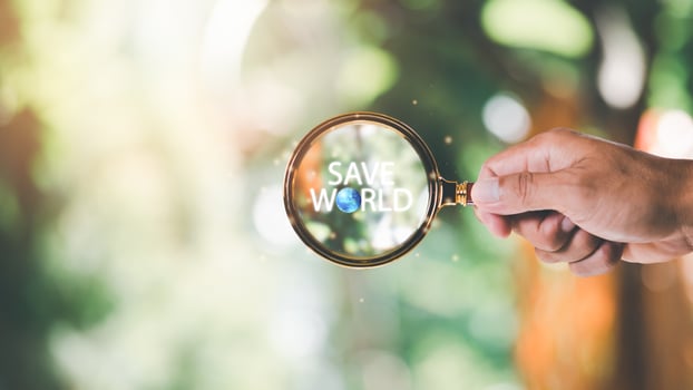 protecting environment alternative energy Sustainable renewable energy sources Green energy innovation and environmentally friendly energy technology,Magnifying glass in human hand and text save world photo