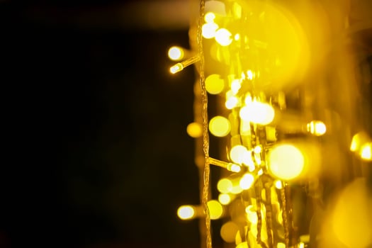 Closeup blurred and bokeh of Christmas lights and refection lighting on black background. photo