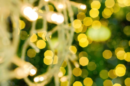 Blurred of Christmas lights on blurry and bokeh of Christmas lighting  background. photo