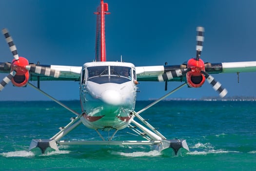 Exotic scene with seaplane on Maldives sea landing. Vacation or holiday in Maldives concept background photo