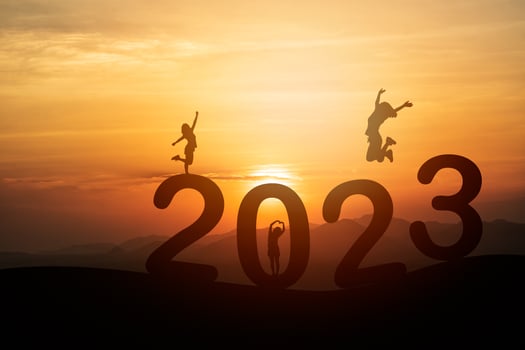 Woman jump happy new year 2023 concept, silhouette of woman jumping over barrier cliff and success with beautiful sunset background. Happy New Year 2023 use for web banner and advertisement. photo