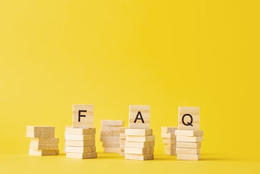 Wooden blocks with word FAQ on the yellow baclground. photo
