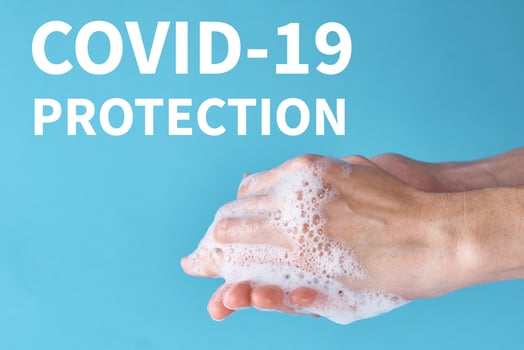 Concept of COVID-19 outbreak health protection with the antiseptic. Woman wash hands using sanitizer or antiseptic gel as prevention measure for coronavirus on blue background photo