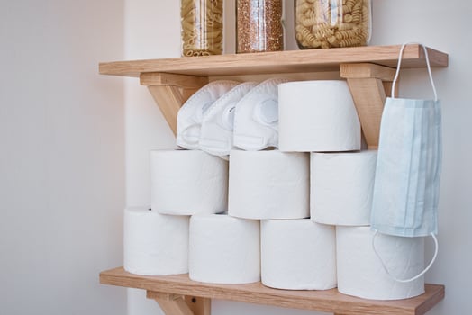 Stocks of toilet paper rolls on shelf photo
