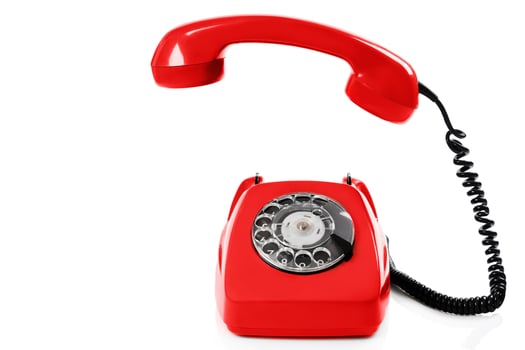 Old fashioned retro red telephone isolated white background photo