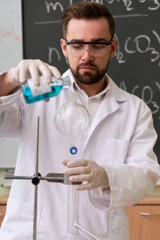 Scientist is pouring substance into the condenser in a laboratory during research photo
