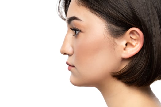 Portrait of young beautiful brunette woman against white photo