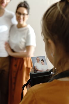 Girl made a photo of her parents using instant camera
