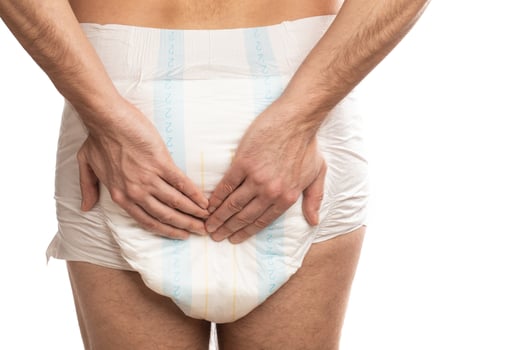 Woman wearing adult diaper against white background photo