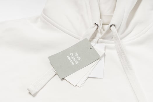 Paper label on a white 100 Percent organic cotton hoodie photo