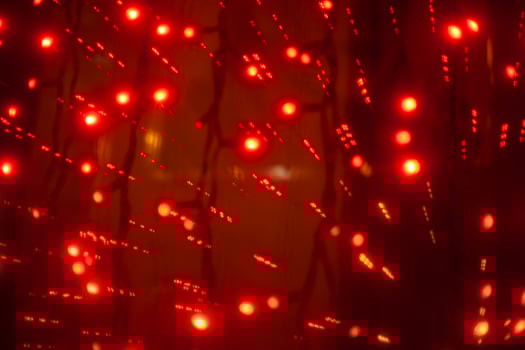 Red garlands in interior. Lights in dark. Room details. Light on window. photo