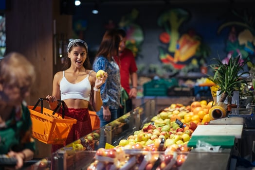 young woman do shopping in supermarket. choosing apples in store photo
