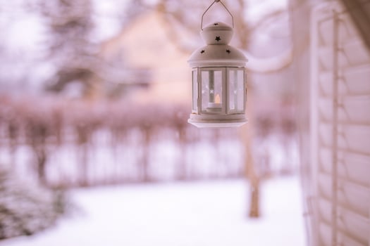 White iron lantern on cozy wonderful winter wonderland background. Warm tones on cold winter scene, relaxing and peaceful view. Perfect winter background, Merry Christmas and happy holidays copy space photo