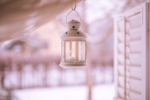 White iron lantern on cozy wonderful winter wonderland background. Warm tones on cold winter scene, relaxing and peaceful view. Perfect winter background, Merry Christmas and happy holidays copy space photo