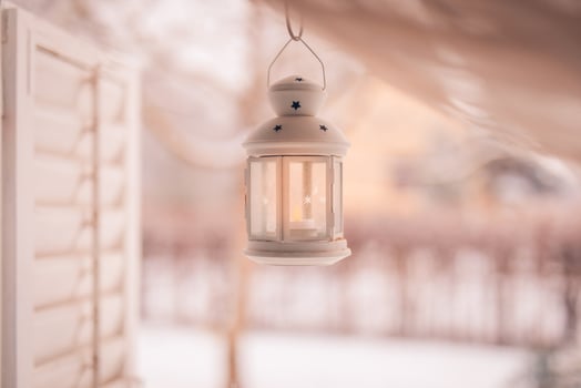 White iron lantern on cozy wonderful winter wonderland background. Warm tones on cold winter scene, relaxing and peaceful view. Perfect winter background, Merry Christmas and happy holidays copy space photo